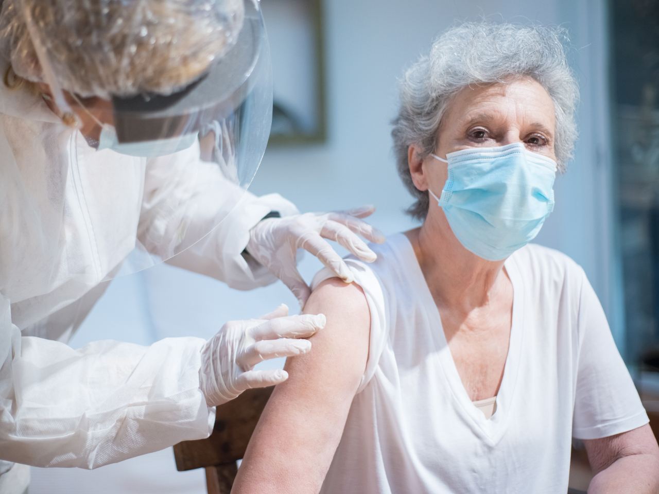 Health professional supporting an older woman