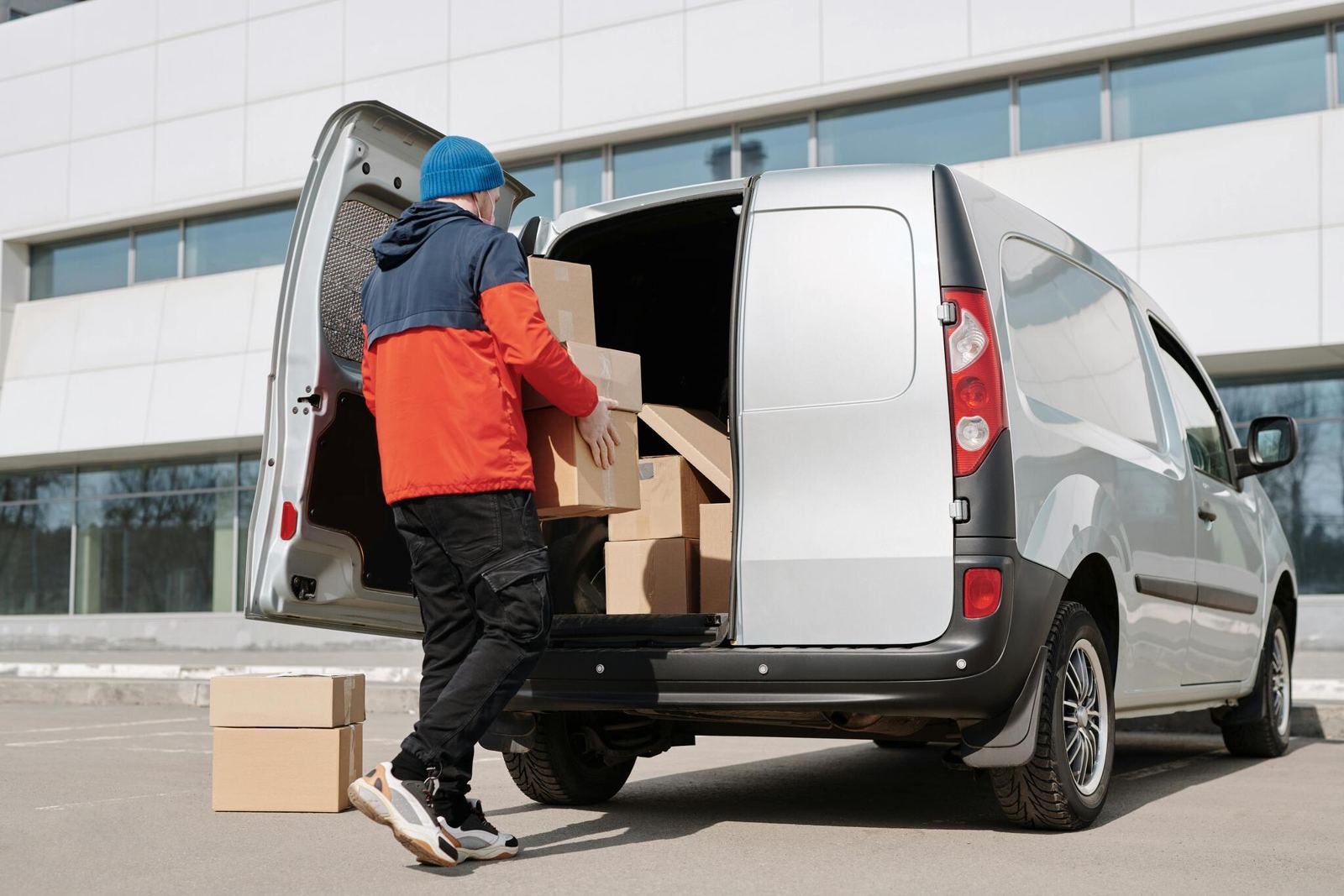 Courier loading boxes into a van